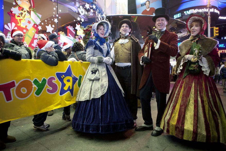 **FILE** Carolers perform for customers waiting in line outside the Toys R Us in Times Square in New York on Nov. 24, 2011. (Associated Press)