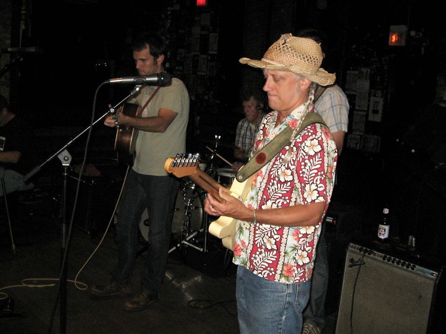 Electric guitarist Steve Doyle, right, and lead singer/guitarist Trevor McSpadden perform during Honky Tonk Happy Hour at the Empty Bottle tavern in Chicago. (Associated Press)