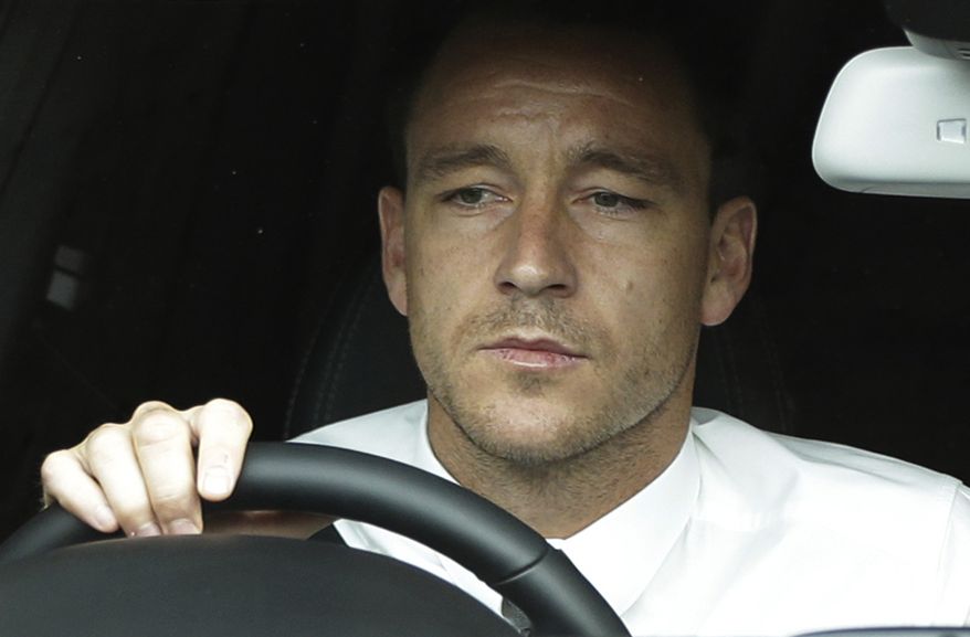 ALTERNATE CROP OF LLP101 Former England soccer captain John Terry drives out of Wembley Stadium in London, Tuesday, Sept. 25, 2012, where the Football Association hearing on a racism charge against him was held. Terry's racism hearing started Monday, a day after the 31-year-old Chelsea defender quit England duty in protest at the case being pursued by the Football Association. Terry was charged by the FA despite being cleared in court of racially abusing Queens Park Rangers defender Anton Ferdinand during a Premier League match in October. (AP Photo/Lefteris Pitarakis)