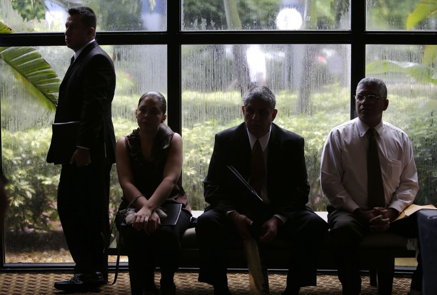 **FILE** Job applicants wait Sept. 17, 2012, for the opening of a job fair held by National Career Fairs in Fort Lauderdale, Fla. (Associated Press)