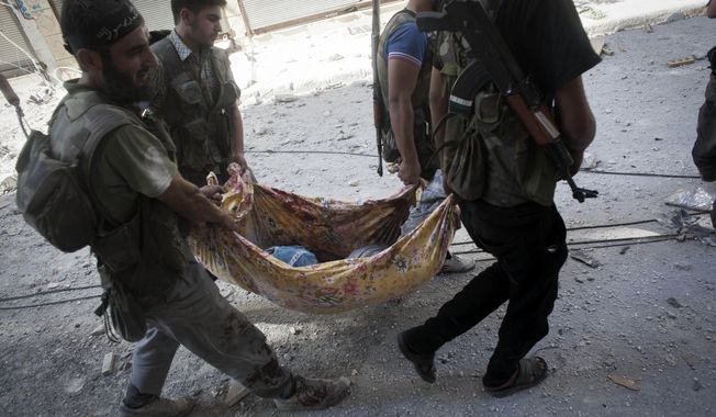 Free Syrian Army fighters carry the body of a comrade away from the front line during clashes against Syrian army forces in Aleppo, Syria, on Wednesday, Sept. 26, 2012. (AP Photo/Manu Brabo)
