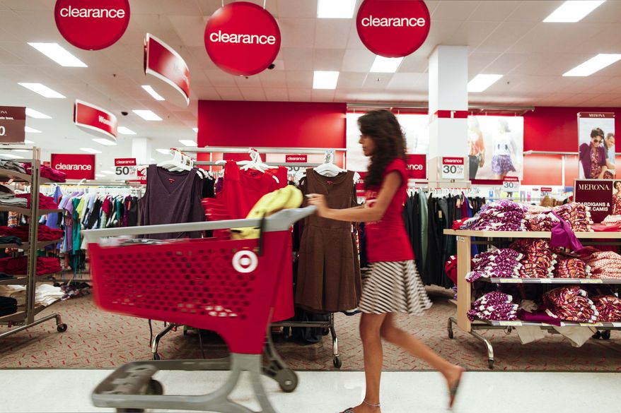 **FILE** A shopper pushes a cart Aug. 22, 2012, through the clearance section of a Target store in Chicago. ((Associated Press)