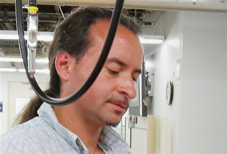 This July 2012 photo shows Andrew Engeldinger working at Accent Signage in Minneapolis. Minneapolis Police Chief Tim Dolan told a Friday, Sept. 28, 2012, news conference that the gunman in Thursday's attack inside a Minneapolis sign company where four people were killed was 36-year-old Engeldinger. Police also say that Engeldinger had been fired hours before the attack. (AP Photo/Finance and Commerce, Bill Klotz)