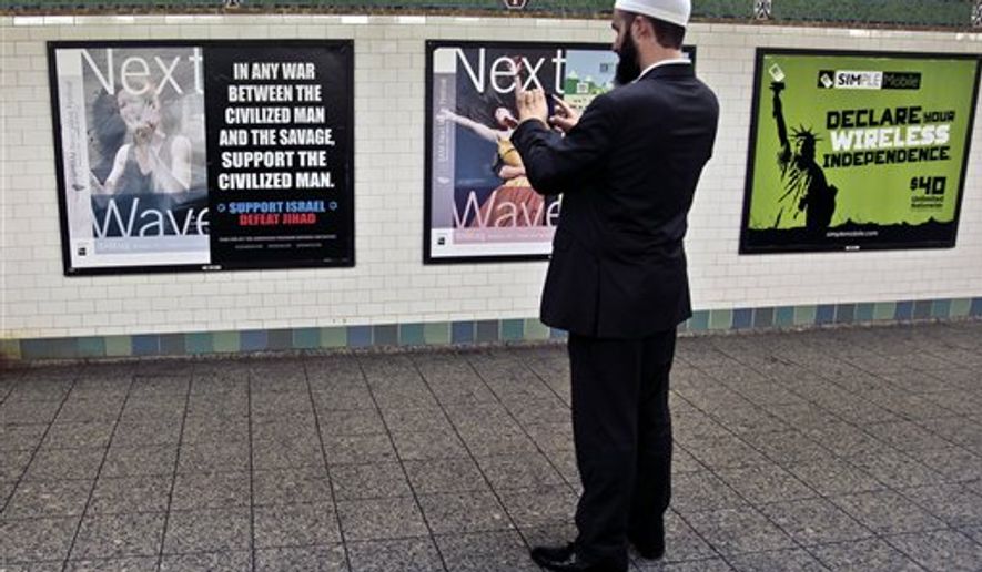 Cyrus McGoldrick, advocacy director for the Council on American-Islamic Relations, makes a photo with his cell phone of an anti-Muslim poster on Monday, Sept. 24, 2012, in New York&#x27;s Times Square subway station. A federal court forced the Metropolitan Transportation Authority to run the ad by blogger Pamela Geller, executive director of the American Freedom Defense Initiative, saying it was protected speech under the First Amendment. (AP Photo/Bebeto Matthews) **FILE**