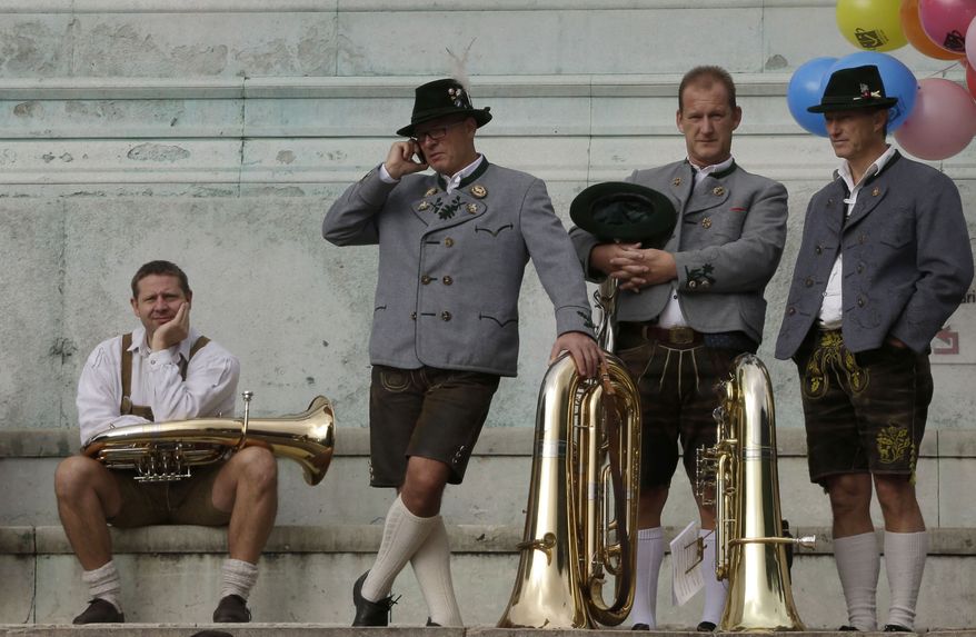 Musicians await the start of a band concert at the famous Oktoberfest beer festival in Munich on Sunday, Sept. 30, 2012. Held from Sept. 22 to Oct. 7, the Oktoberfest will see millions of visitors. (AP Photo/Matthias Schrader)

