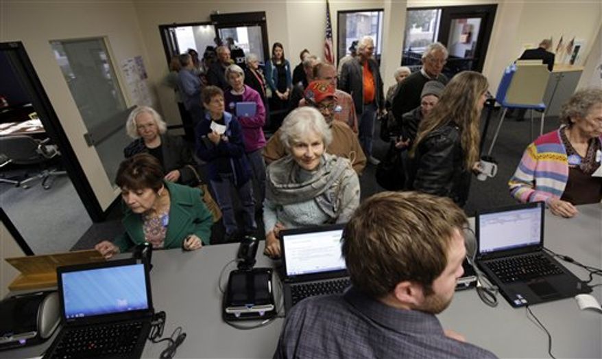 FILE - In this Sept. 27, 2012, photo voters wait for their ballots on day one of early voting for the November presidential election in Des Moines, Iowa. Five weeks to Election Day, President Obama is within reach of the requisite 270 Electoral College votes needed to win a second term according to an Associated Press analysis. (AP Photo/Charlie Neibergall, File)