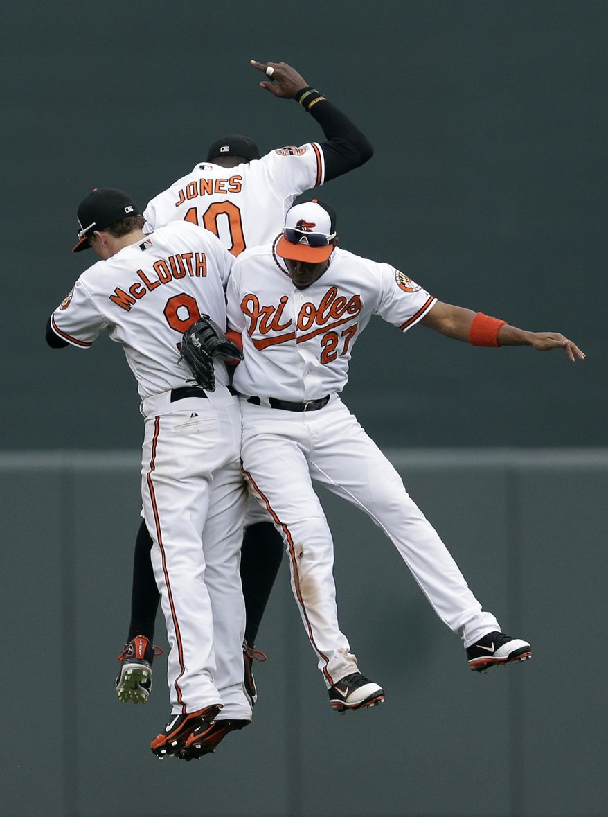Baltimore Orioles' Nate McLouth, left, Adam Jones (10) and Endy Chavez celebrate after a baseball game against the Boston Red Sox in Baltimore, Sunday, Sept. 30, 2012. Baltimore won 6-3. (AP Photo/Patrick Semansky)