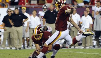 Washington Redskins kicker Billy Cundiff, right, makes the winning 41-yard field goal as Sav Rocca holds in the final seconds of an NFL football game against the Tampa Bay Buccaneers, Sunday, Sept. 30, 2012, in Tampa, Fla. The Redskins won 24-22. (AP Photo/Brian Blanco)