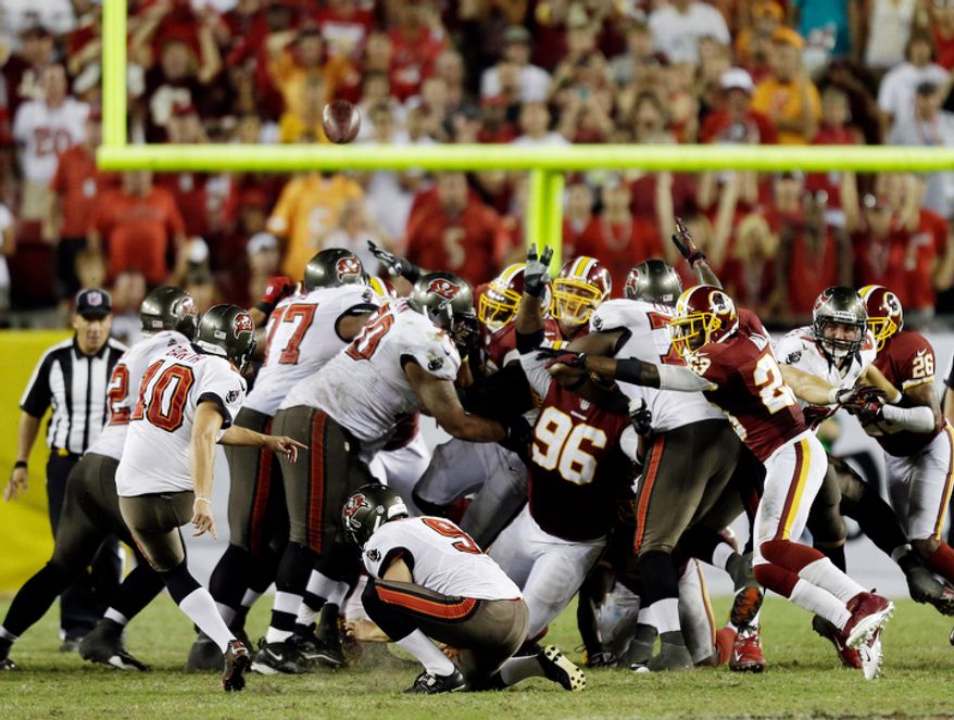 Tampa Bay Buccaneers kicker Connor Barth (10, left) kicks a 47-yard field goal against the Washington Redskins during the fourth quarter. (AP Photo/Chris O'Meara)