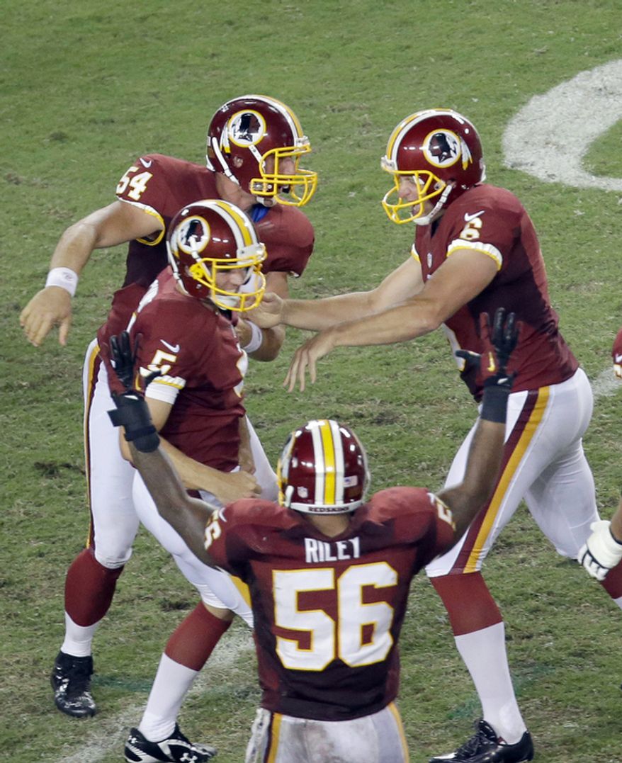 The Redskins celebrate with kicker Billy Cundiff after defeating the Buccaneers 24-22 Sunday, Sept. 30, 2012, in Tampa, Fla. (AP Photo/Margaret Bowles)