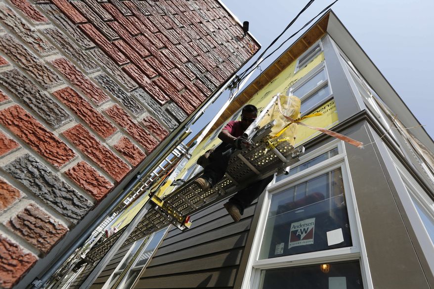 A construction worker adjusts a scaffold at the site of a new residential project in the East Boston neighborhood of Boston on Friday, Aug. 17, 2012. (AP Photo/Michael Dwyer)