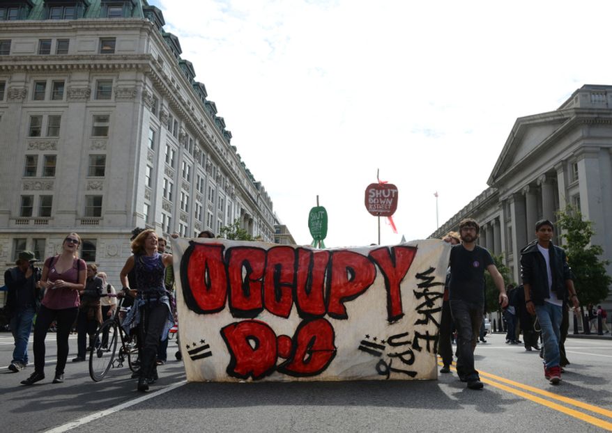 The Occupy movement marches on Washington, D.C. on the one-year anniversary of Occupy D.C., Monday, Oct. 1, 2012. "Real change takes time, even generations," said one occupier. Another said that they are now changing their tactic from long-term occupation to short bursts of protests so that occupiers can go to work and earn a living. (Barbara L. Salisbury/The Washington Times)