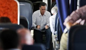 Republican presidential candidate and former Massachusetts Gov. Mitt Romney talks with Sen. Rob Portman, R-Ohio, who has also been his debate practice partner, on his campaign charter plane en route Denver, Monday, Oct. 1, 2012. (AP Photo/Charles Dharapak)