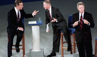 President George H.W. Bush talks with independent candidate H. Ross Perot (center) as Democratic candidate Bill Clinton stands aside at the end of their second debate. (Associated Press/File)
