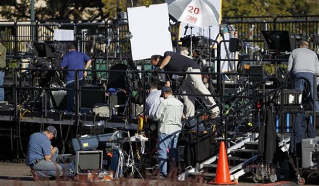 Television crews setup on a riser out side of the Magness Arena at the University of Denver in Denver,Tuesday, Oct. 2, 2012, where the first presidential debate between President Obama and Republican presidential candidate Mitt Romney is scheduled for Oct. 3. (AP Photo/Ed Andrieski)