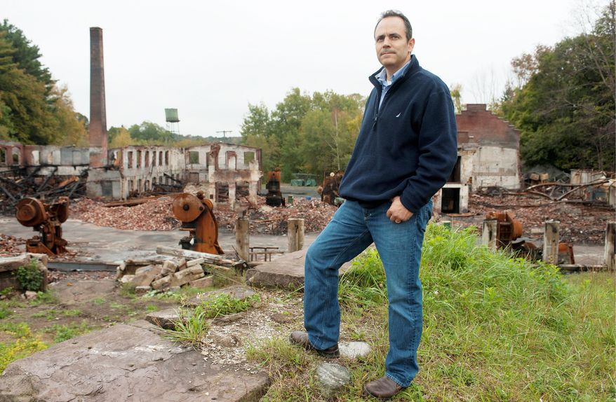 Matt Bevin, owner of 180-year-old Bevin. Bros. bell-manufacturing company in East Hampton, Conn., stands by the remains of his burned-out factory. Production has resumed in a rented warehouse, and a new factory will be built. (Associated Press)