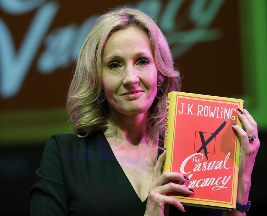 "Harry Potter" author J.K. Rowling poses with her new book, the adult novel "The Casual Vacancy," at the Southbank Centre in London on Thursday, Sept. 27, 2012. (AP Photo/Lefteris Pitarakis)