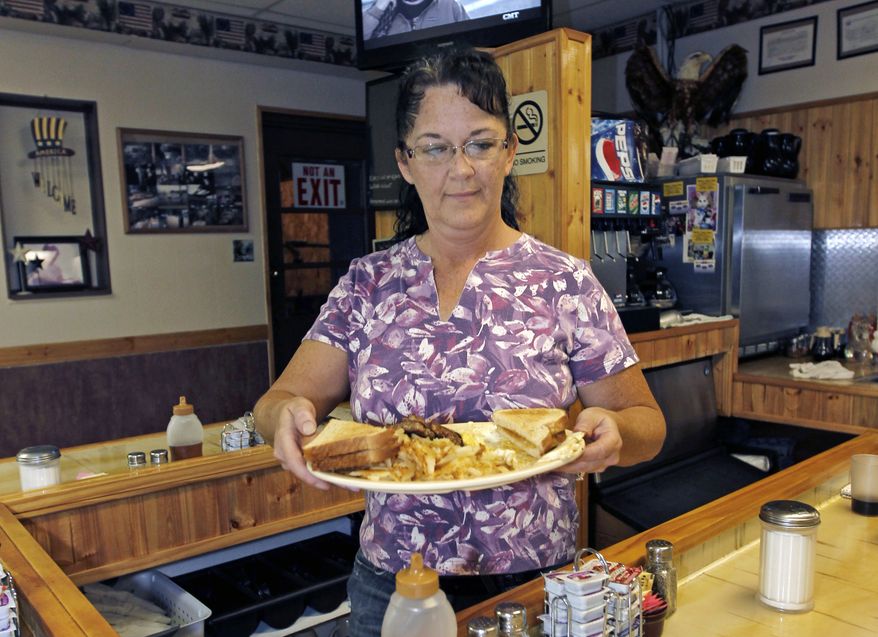 **FILE** Millie Brown, a cook and waitress at Buch's Truck Stop in Steubenville, Ohio, serves a breakfast Sept. 27, 2012. (Associated Press)