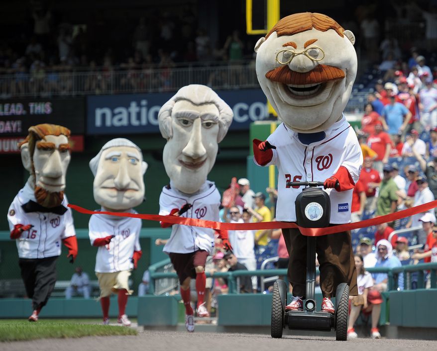 This photo taken June 1, 2012 shows Teddy Roosevelt , left, crossing the finish line riding a Segway, defeating the other Presidents in the "Presidents Race" held between innings at the Washington Nationals baseball game at Nationals Park in Washington. (AP Photo/John McDonnell, The Washington Post)WIRES OUT MAGS OUT TV OUT NEW YORK TIMES WASHINGTON TIMES OUT NO TRADES NO SALES MANDATORY CREDIT