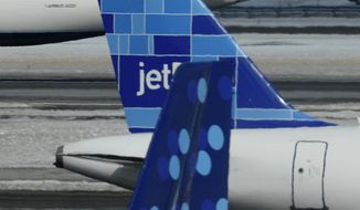 **FILE** JetBlue planes depart and arrive at JFK International Airport in New York on Feb. 18, 2007. (Associated Press)