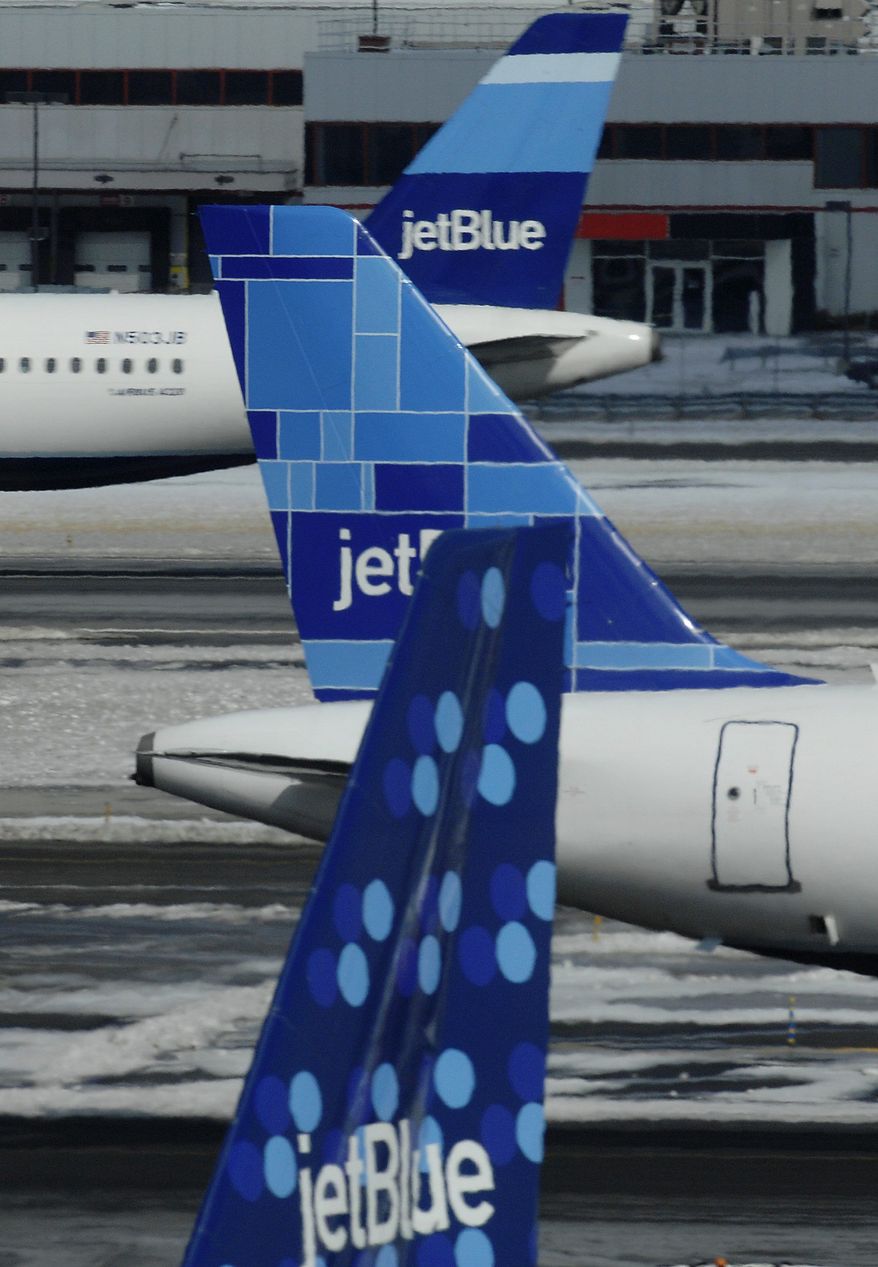 **FILE** JetBlue planes depart and arrive at JFK International Airport in New York on Feb. 18, 2007. (Associated Press)