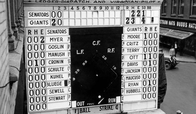 FILE- In this Oct. 3, 1933, file photo, a scoreboard showing Game 1 of baseball&#x27;s World Series between the Washington Senators and New York Gians is displayed outside a building in Norfolk, Va. In clinching a playoff spot, the Nationals put the nation&#x27;s capital in baseball&#x27;s postseason for the first time in nearly 80 years. (AP Photo/Virginian-Pilot, Charles S. Borjes, File)