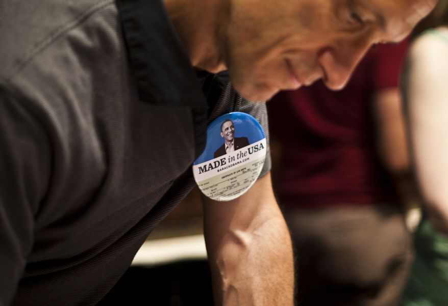 An Obama supporter signs in before watching the first presidential debate between President Obama and Republican nominee Mitt Romney during a watch party put on by the Arlington Young Democrats and the Arlington County Democratic Committee at Bailey's Pub in Ballston Common Mall, Ballston, Va., Wednesday, Oct. 3, 2012. (Craig Bisacre/The Washington Times)
