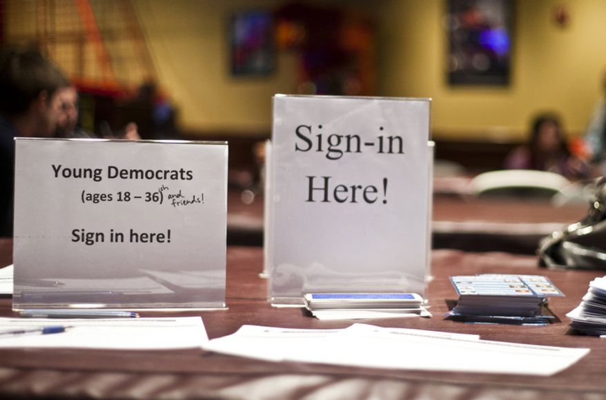 The Arlington Young Democrats and the Arlington County Democratic Committee put on a watch party at Bailey's Pub in Ballston Common Mall, Ballston, Va., Wednesday, Oct. 3, 2012. (Craig Bisacre/The Washington Times)