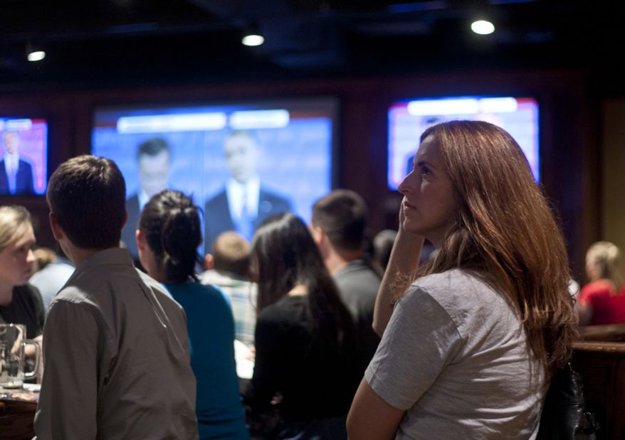 Melissa Throp of Arlington, Va., watches the first presidential debate between President Obama and Republican nominee Mitt Romney during a watch party put on by the Arlington Young Democrats and the Arlington County Democratic Committee at Bailey's Pub in Ballston Common Mall, Ballston, Va., Wednesday, Oct. 3, 2012. (Craig Bisacre/The Washington Times)