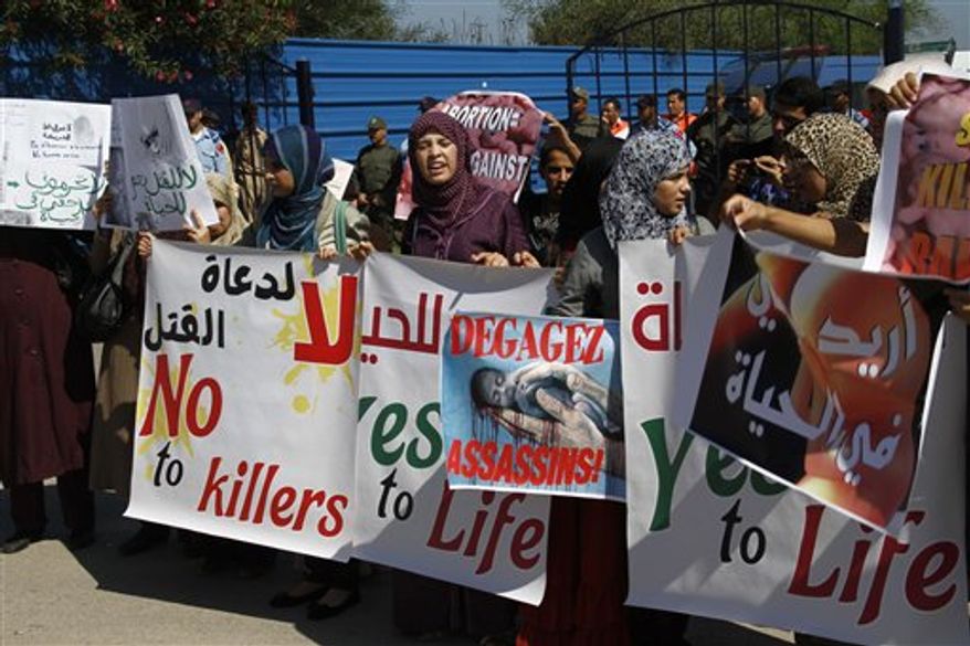 Moroccan women protest the scheduled arrival of a Dutch ship advocating safe and legal abortions in Smir, Morocco Thursday oct 4 2012. Their signs read "no to abortion." Moroccan authorities sealed a port where a Dutch abortion ship was set to arrive , while demonstrators protested against its arrival . (AP Photo/Paul Schemm).