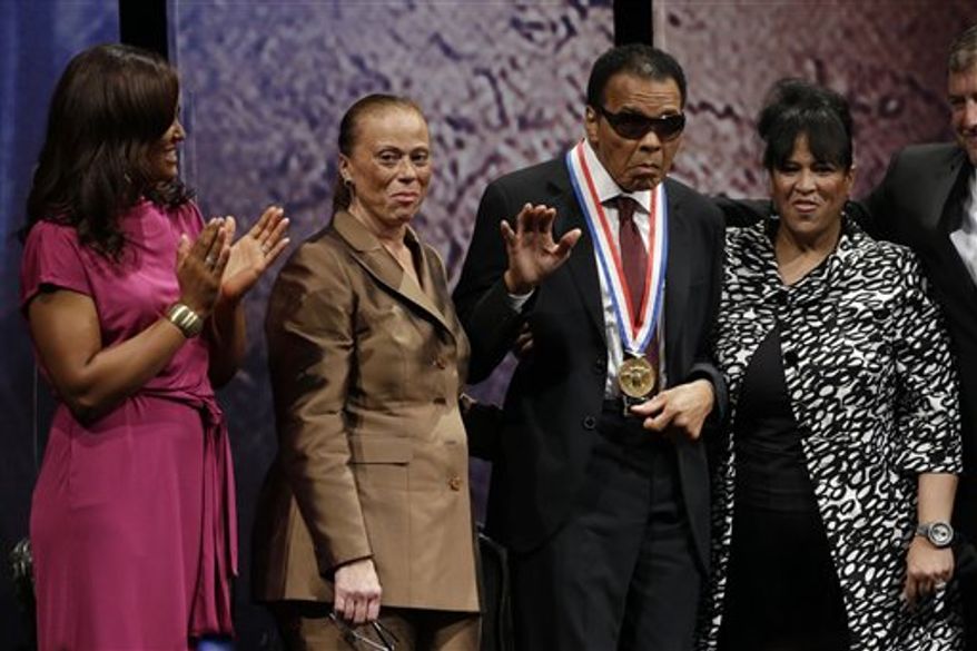 ** FILE ** Retired boxing champion Muhammad Ali, center, stands alongside his daughter, Laila Ali, left, wife Lonnie Ali, and his sister-in-law Marilyn Williams, right, after receiving the Liberty Medal during a ceremony at the National Constitution Center, Thursday, Sept. 13, 2012, in Philadelphia. The honor is given annually to an individual who displays courage and conviction while striving to secure liberty for people worldwide. (AP Photo/Matt Rourke)