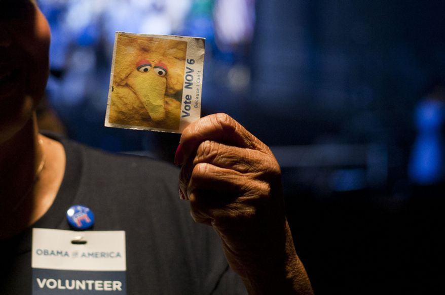 Supporters wear Big Bird pins from Sesame Street during President Obama's campaign event Friday, Oct. 5, 2012, at George Mason University in Fairfax, Va. The use of Big Bird pins comes days after Republican presidential candidate Mitt Romney referenced to the Sesame Street character during the debate this past Wednesday. (Craig Bisacre/The Washington Times)