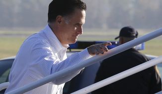 Republican presidential candidate Mitt Romney boards his campaign plane at Weyers Cave-Shenandoah Valley Airport in Weyers Cave, Va., on Oct. 5, 2012. (Associated Press)