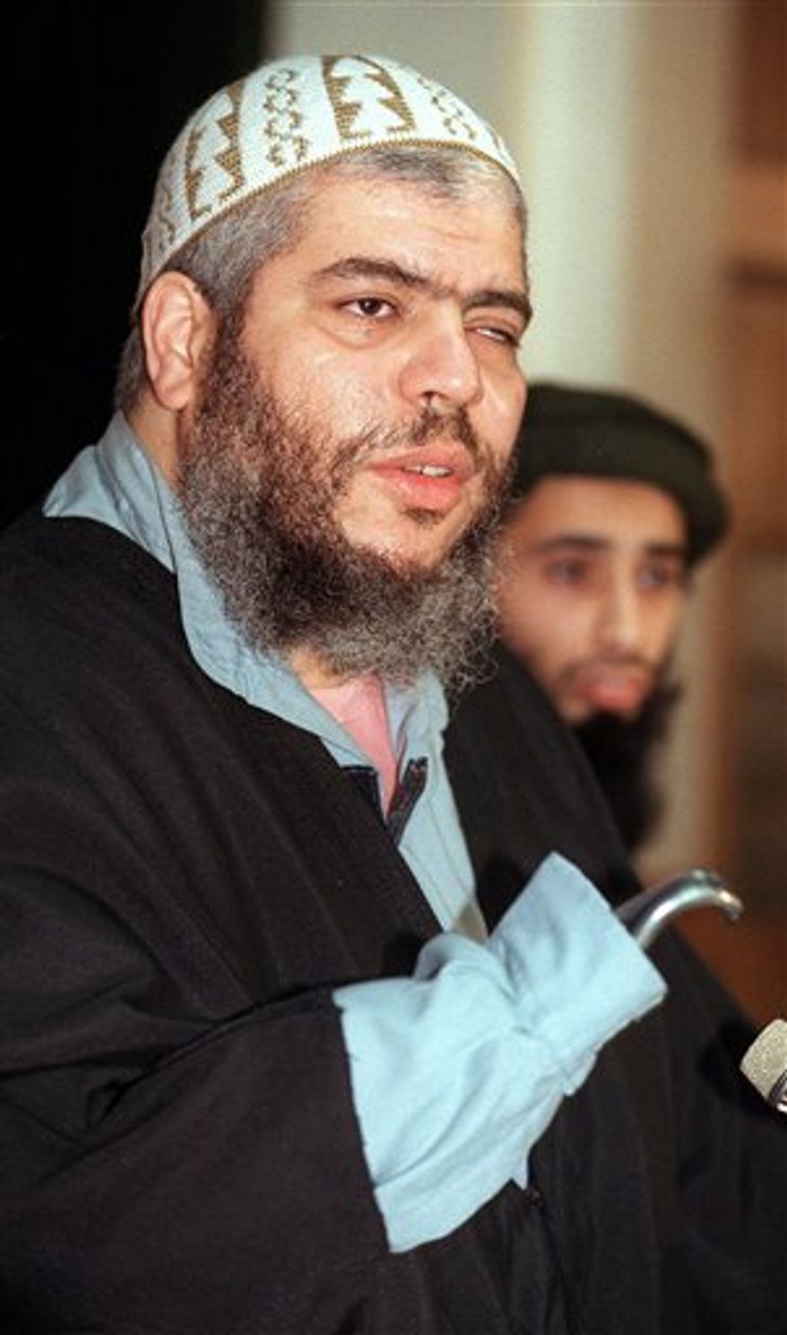 ** FILE ** In this Jan. 20, 1999, file photo, Muslim cleric Abu Hamza al-Masri speaks at a press conference in London. (AP Photo/Alastair Grant, File)