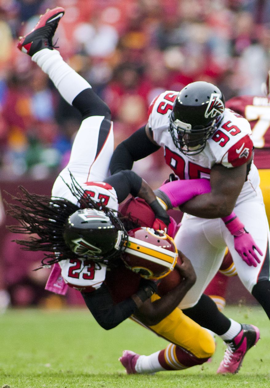 Washington Redskins quarterback Robert Griffin III (10) is sacked in the first quarter by Atlanta Falcons cornerback Dunta Robinson (23) , Landover, Md., Sunday, Oct. 7, 2012. (Craig Bisacre/The Washington Times)
