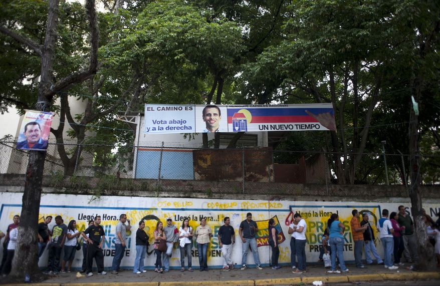 Residents line up at a polling station to vote in presidential elections in Caracas, Venezuela, on Sunday, Oct. 7, 2012. President Hugo Chavez is running against opposition candidate Henrique Capriles. (AP Photo/Sharon Steinmann)