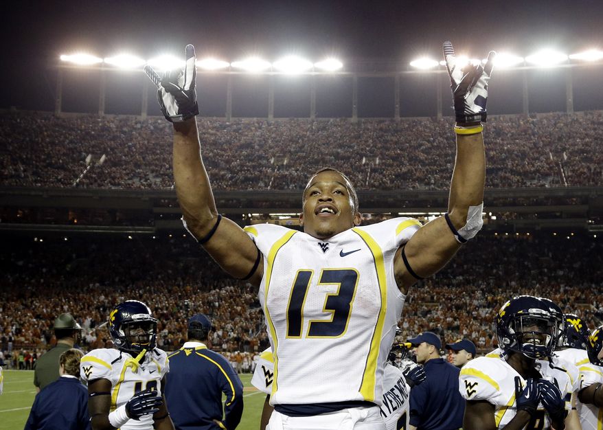 West Virginia's Andrew Buie reacts after scoring against Texas during the fourth quarter of an NCAA college football game on Saturday, Oct. 6, 2012, in Austin, Texas. West Virginia won 48-45. (AP Photo/Eric Gay)