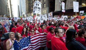 **FILE** Thousands of public school teachers rally Sept. 10, 2012, outside the Chicago Public Schools district headquarters on the first day of strike action over teachers&#39; contracts in Chicago. (Associated Press)