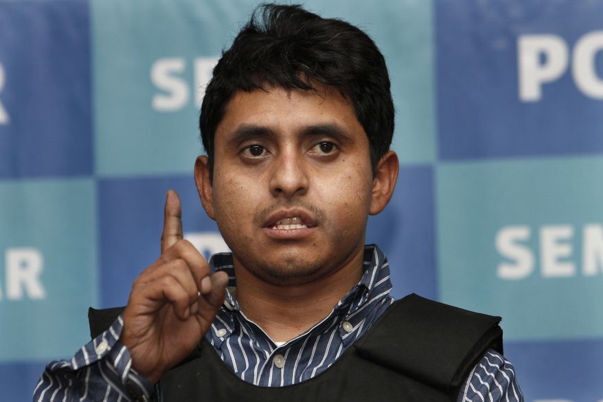 Salvador Alfonso Martinez, also known as "La Ardilla," or "Squirrel" in English, holds up his right finger while presented to the press under the custody of Navy marines at the Organized Crime Special Investigations Unit headquarters in Mexico City on Oct. 8, 2012. According to federal authorities, Martinez is one of the most wanted criminals in Mexico, and is allegedly a top regional leader of the Zetas drug cartel. (Associated Press)