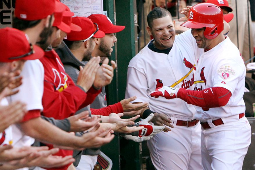 St. Louis Cardinals' Yadier Molina, second from right, congratulates Carlos Beltran after Beltran hit a solo home run against the Washington Nationals during the sixth inning of Game 2. (AP Photo/St. Louis Post-Dispatch, Chris Lee)
