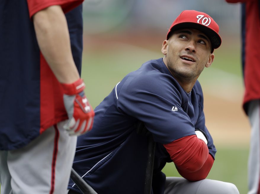 Washington Nationals' Ian Desmond, right, looks up as he talks with teammate Bryce Harper during baseball practice, Saturday, Oct. 6, 2012, in St. Louis. The Nationals and the St. Louis Cardinals are scheduled to play Game 1 in the National League division series on Sunday. (AP Photo/Jeff Roberson)