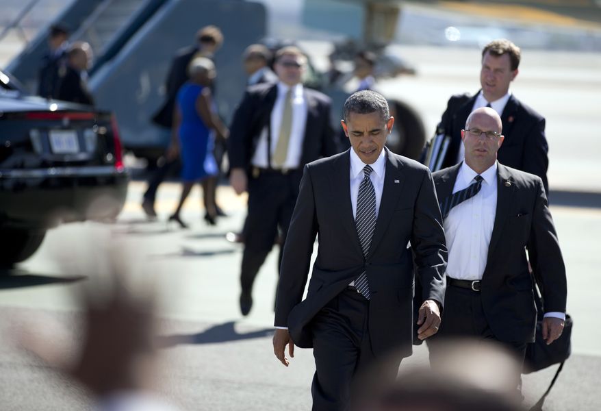 President Obama crosses the tarmac to greet supporters as he arrives Oct. 8, 2012, on Air Force One at San Francisco International Airport. (Associated Press)