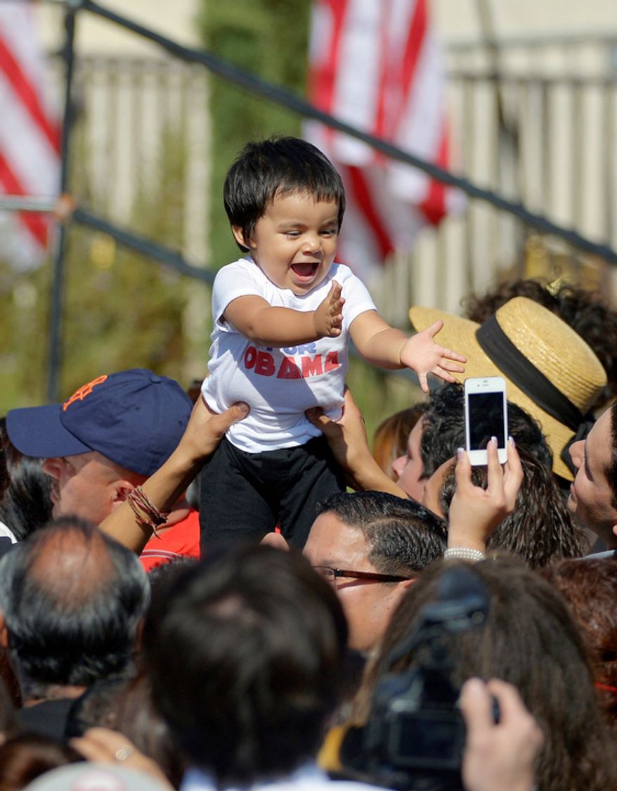 A baby is held up in the crowd Oct. 8, 2012, before President Obama announces the establishment of the Cesar E. Chavez National Monument in Keene, Calif. (Associated Press)