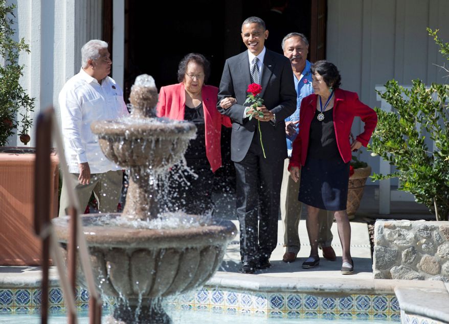 President Obama holds a commemorative red rose as he walks with Cesar Chavez' widow, Helen F. Chavez (second from left); Chavez' son, Paul F. Chavez (left), president of the Cesar E. Chavez Foundation; Dolores Huerta (right), co-founder of the United Farm Workers; and Arturo S. Rodriguez, president of the United Farm Workers, as they tour the Cesar E. Chavez National Monument Memorial Garden in Keene, Calif., on Oct. 8, 2012. (Associated Press)