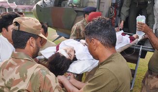 Pakistani troops carry an injured Pakistani girl, Malala Yousufzai, from a helicopter to a hospital Tuesday in Peshawar, Pakistan. The Taliban claimed responsibility for a gunman’s attack on the teen, who has championed the education of girls. (Associated Press)
