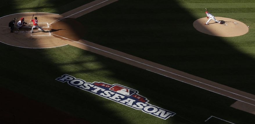 St. Louis Cardinals starting pitcher Jaime Garcia, right, throws to Washington Nationals' Bryce Harper during the first inning of Game 2 of the National League division baseball series, Monday, Oct. 8, 2012, in St. Louis. (AP Photo/Charlie Riedel)