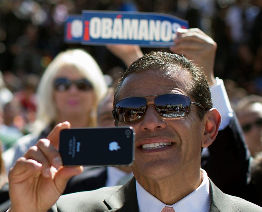 Los Angeles Mayor Antonio Villaraigosa takes a photo with his phone as President Obama speaks at the Cesar E. Chavez National Monument on Monday, Oct. 8, 2012, in Keene, Calif. (AP Photo/Carolyn Kaster)