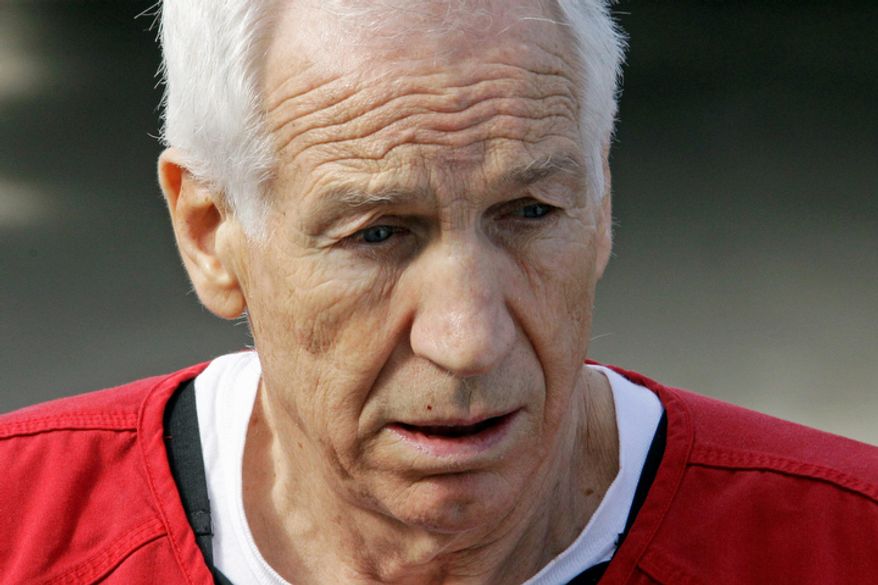 Former Penn State University assistant football coach Jerry Sandusky leaves the Centre County Courthouse in Bellefonte, Pa., on Oct. 9, 2012, after being sentenced to at least 30 years in prison in the child sexual abuse scandal that brought shame to Penn State and led to coach Joe Paterno's downfall. (Associated Press)
