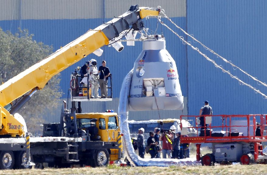 Felix Baumgartner, in pressurized suit on platform at left, prepares to enter the balloon capsule in Roswell, N.M. on Oct. 9, 2012. Baumgartner will attempt to break the speed of sound with his own body by jumping from the space capsule lifted by a 30 million cubic foot helium balloon. (Associated Press)