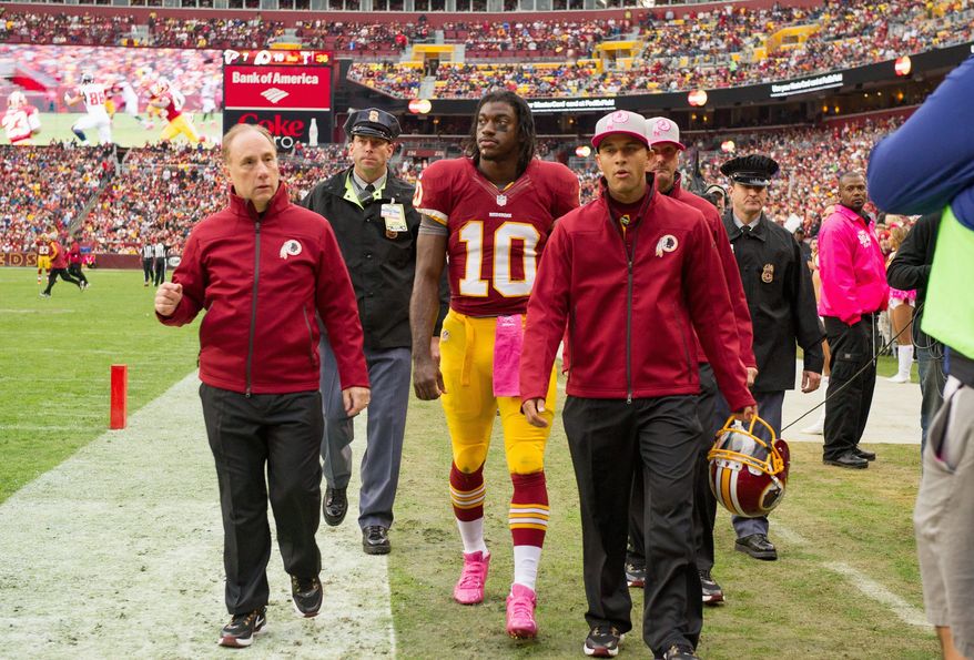 andrew harnik/the washington times
Redskins quarterback Robert Griffin III was taken to the locker room Sunday after suffering a concussion on a hit from Atlanta linebacker Sean Weatherspoon. Griffin returned to practice Wednesday.